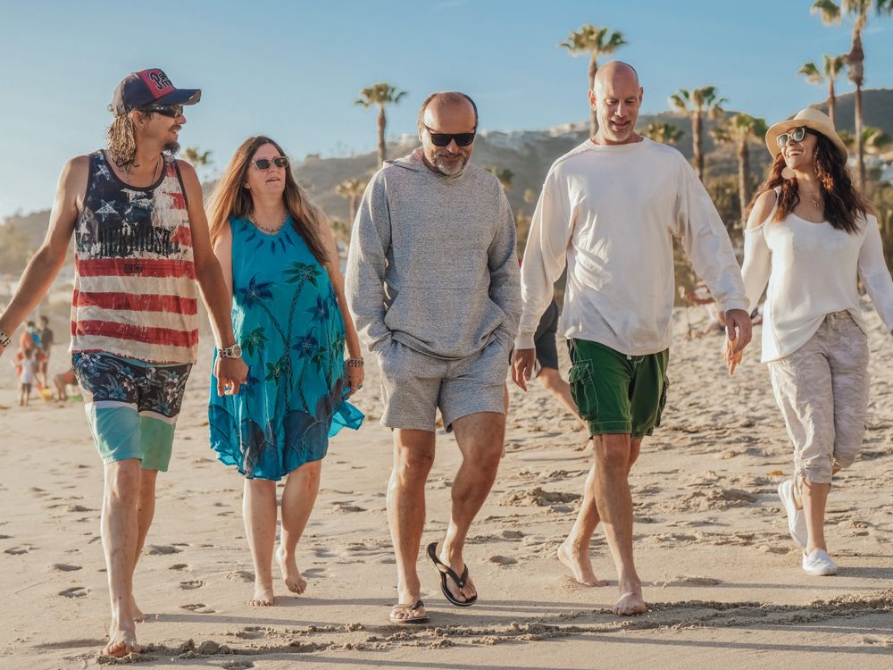 Friends enjoying a sunny walk together by the sea